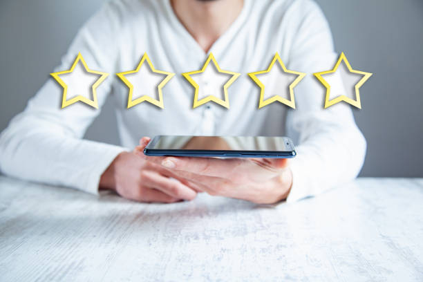 istock man hand phone with stars in screen 1148043639
