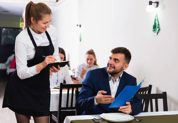 istock Woman waiter is taking order from client in restaurante 1148043873