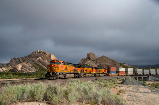 May 6, 2019\nCajon Junction, California\nWestbound BNSF intermodal container train descends Cajon Pass at Mormon Rocks near Cajon Junction. Sandstone formations were created by a sub-fault of the San Andreas Fault.