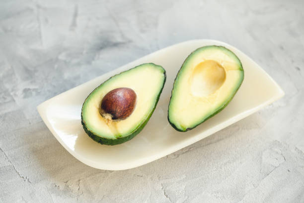 istock Two halves of avocado on a plate 1148046139