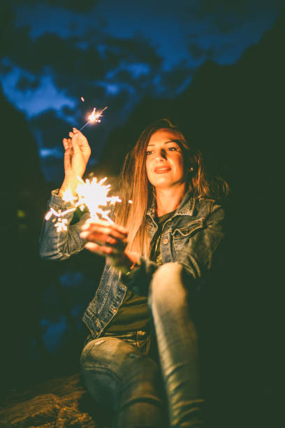 istock Female Using Sparklers To Have Fun At Night Time Trip 1148046537