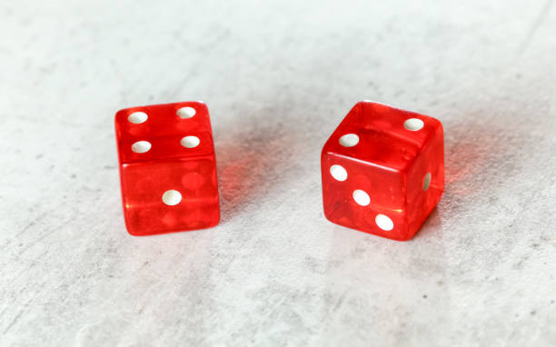 istock Two translucent red craps dices on white board showing Easy Six Jimmie Hicks umber 4 and 2 1148046881