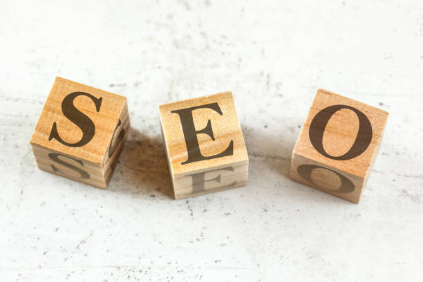 istock Three wooden cubes with letters SEO stands for Search Engine Optimization on white board. 1148047773