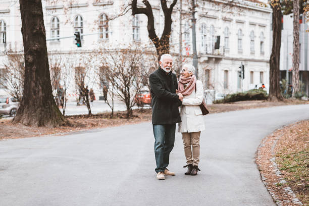 istock Happy Elderly Senior Couple In Park 1148047963