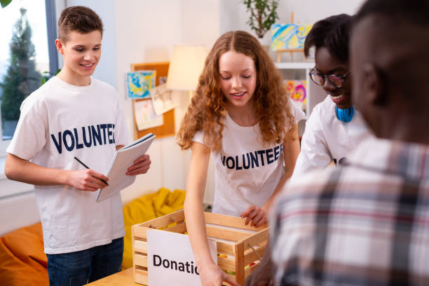 istock Teenagers working in organization gathering items for donation 1148048195