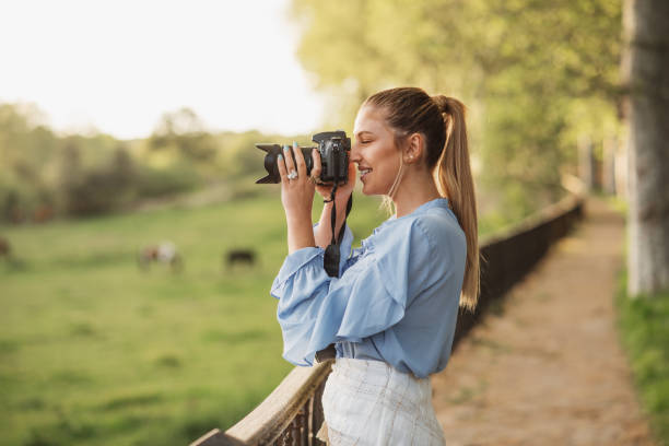 istock Young woman taking a picture with a DSLR camera 1148048253