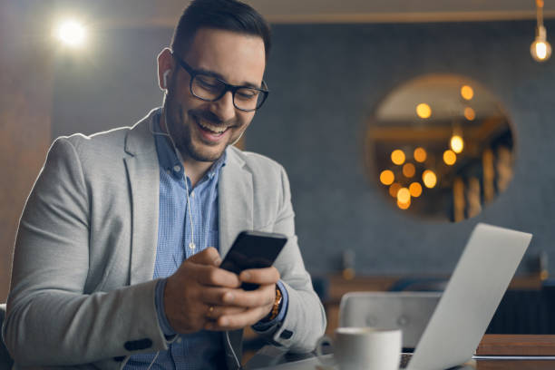 istock Businessman using mobile phone in cafe 1148052320