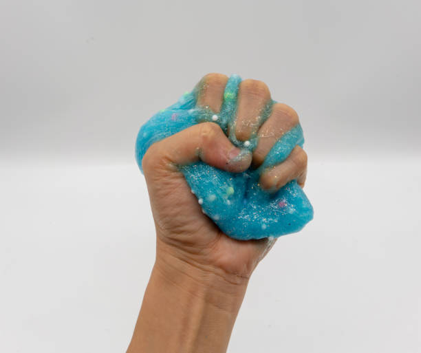 istock Hand playing transparent blue glitter slime isolated on white background 1148052559