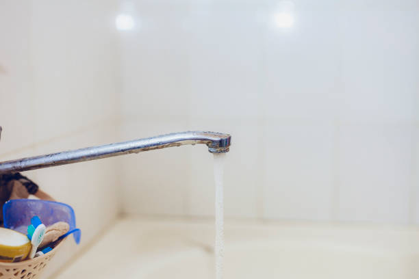 Bathroom. Open bath water tap with running water. water tap