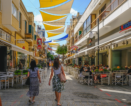 Nicosia, Cyprus - May 14, 2018: View of Ledra Street in the morning of an early summer's day with rear view of two lady shoppers.