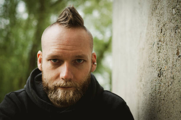 istock serious or calm young bearded man sitting in front of the camera 1148061848