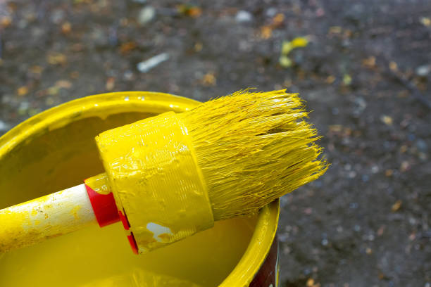 istock Can of yellow paint and brush 1148062055