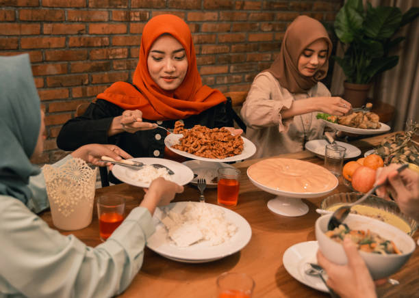 istock muslim people having dinner break fasting together 1148064925