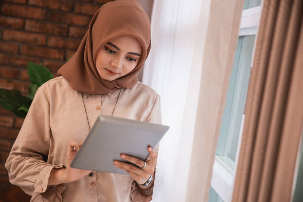 istock muslim smart woman with tablet pc 1148064948