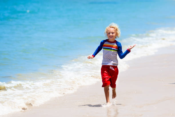 istock Kids playing on beach. Children play at sea. 1148065126