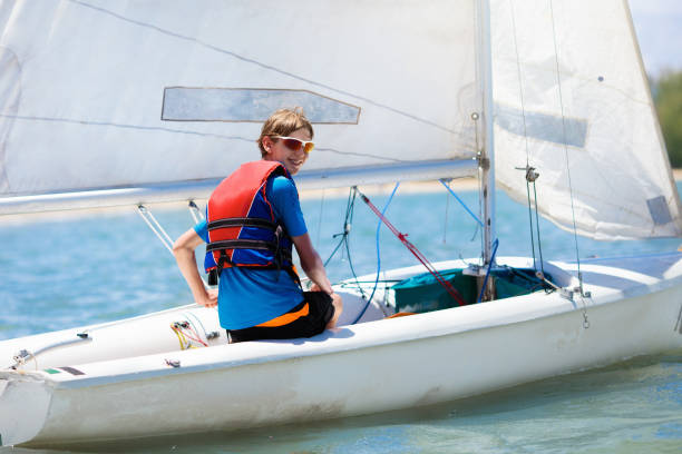 istock Child sailing. Kid learning to sail on sea yacht. 1148065762