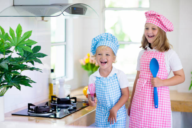 istock Kids cook in white kitchen. Children cooking. 1148068722