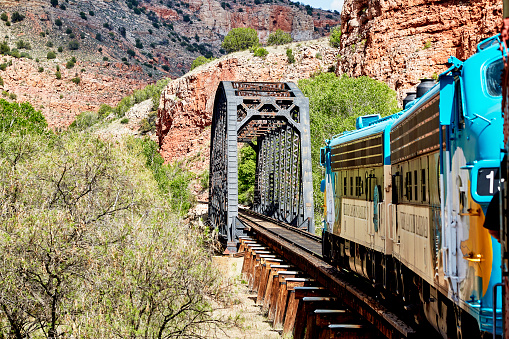 Clarkdale, Arizona, USA - May 4, 2019: Verde Canyon Railroad train engine driving on scenic route over a bridge