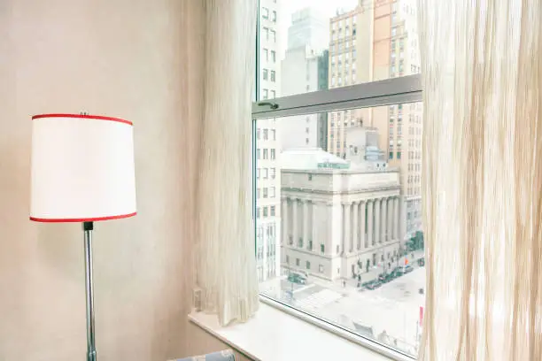 Photo of Retro red lamp by window view midtown New York City NYC cityscape in Manhattan hotel apartment condo high rise building