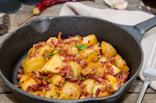 istock Tyrolean fried potatoes with bacon and onion in a pan. 1148079879
