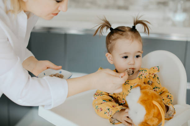istock Adult feeding baby 1148080860