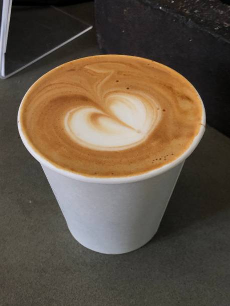 istock Top down view from above of a flat white coffee with latte art and a grey background 1148084023