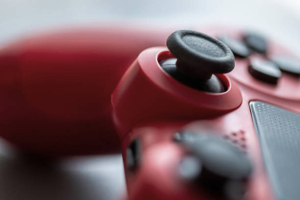 Close up of a wireless red e-sports gaming controller. Close up of a wireless red e-sports gaming controller. game controller photos stock pictures, royalty-free photos & images