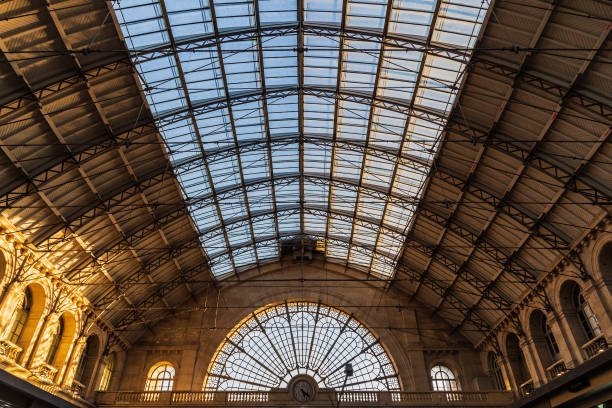 Paris, France - March 18, 2014: People walk past the entrance to the Gare De L'Est, one of the main railway stations in Paris. Designed by architect Francois Duquesnay, it was first opened in 1849.