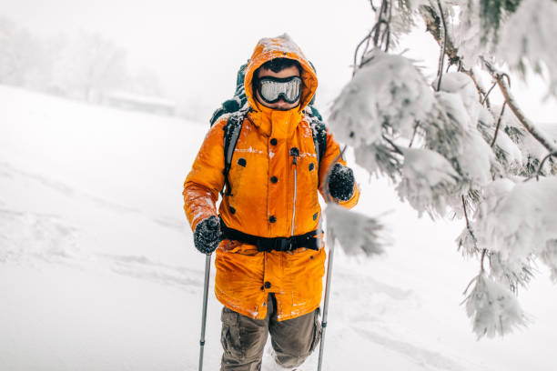 Man exploring mountain, hiking with backpack on his back