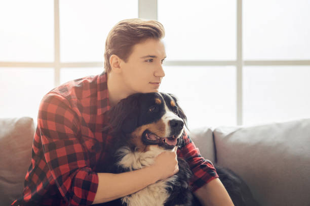 istock Young person with dog at home leisure 1148093043