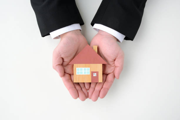 istock House object in business man's hand 1148093512