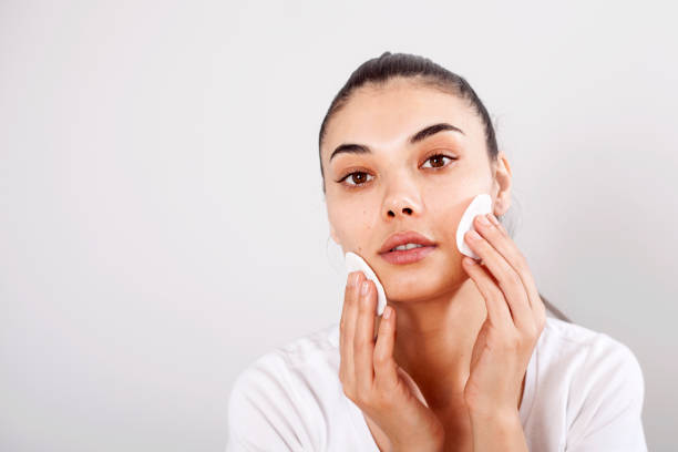 istock Beautiful brunette woman removing makeup from her face 1148095497