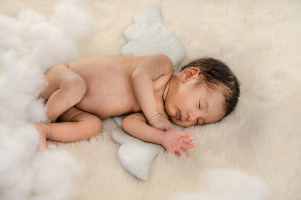 istock cute Asian infant baby boy sleeping on a blanket 1148099048