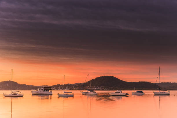 istock High Clouds, Boats, Reflections and Sunrise on the Bay 1148105222