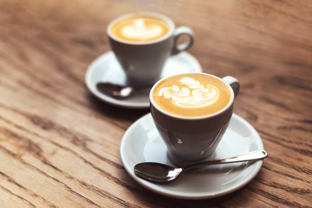 istock Two cups of coffee on wood table. 1148105947