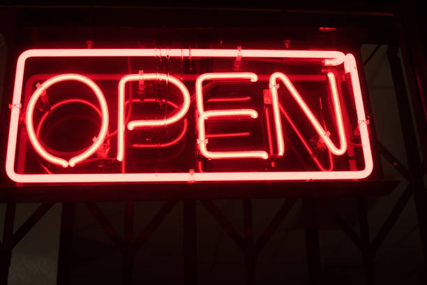 istock Brightly lit open sign on window of business 1148113363