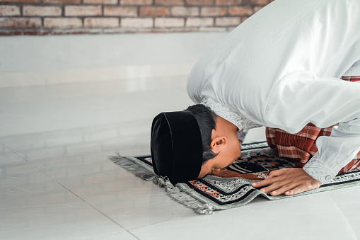 muslim male sujud. asian man praying or solat in islam