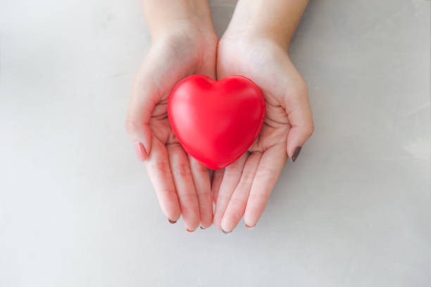 istock Red heart shape rubber on beautiful woman hand 1148117446