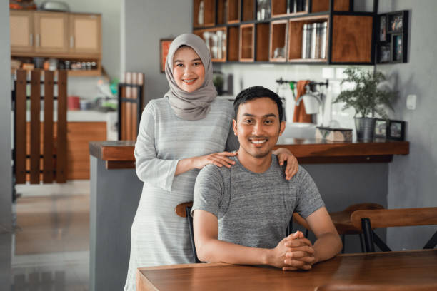 istock muslim couple sitting in dining room together 1148117541