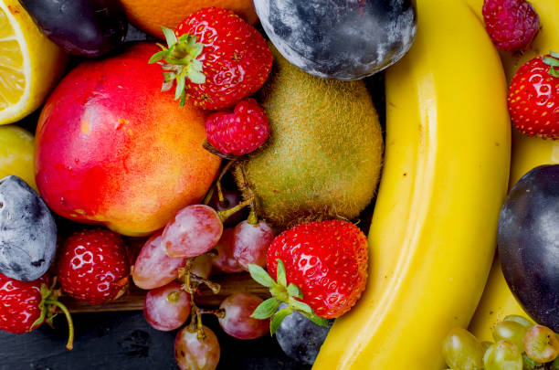 istock dried and raw fruits on dark background 1148128290