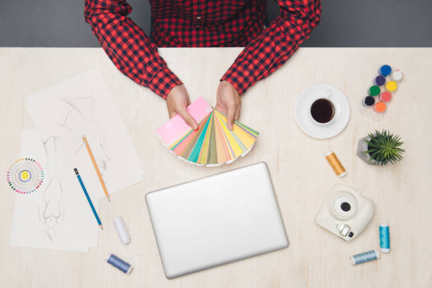 istock Male student working with laptop on desk. Top view 1148128424