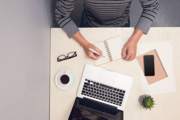 istock Businessman working at office desk and using laptop, top view. 1148129278