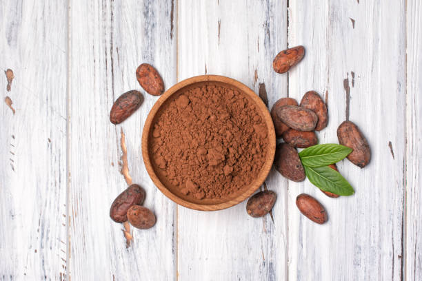 istock Top view on cocoa beans and powder in bowl 1148132738