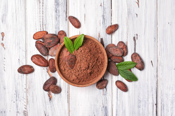 istock Top view on cocoa beans and powder in bowl 1148132746
