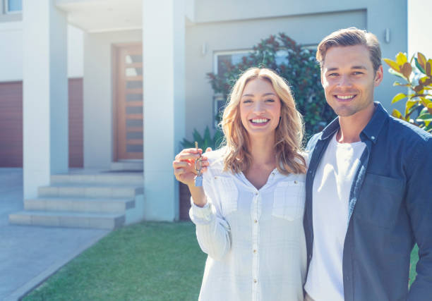 istock Young couple holding their new house key. 1148133817