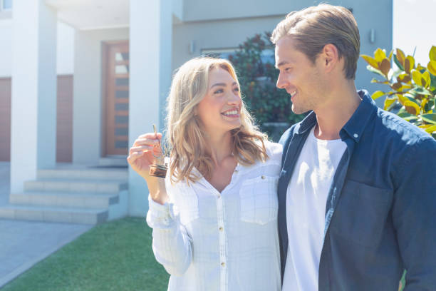 istock Young couple holding their new house key. 1148133824