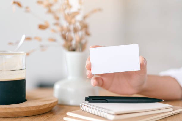istock A hand holding white empty business card 1148134266