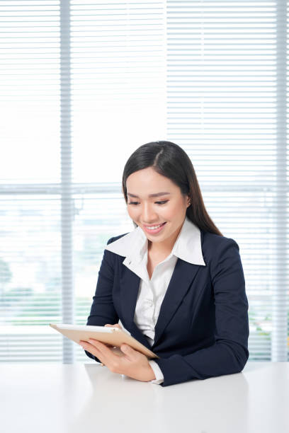 istock Business woman examining documents in office. 1148135625