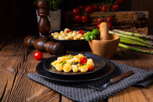 istock crispy gnocchi with roasted asparagus and tomatoes 1148136679