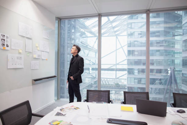 istock Man looking at idea bulletin board in office 1148138174